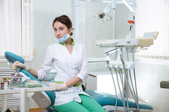 Dentist woman with medical instruments in the dental office doing procedures
