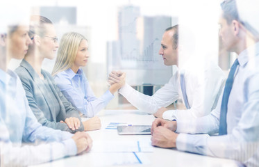 businesswoman and businessman arm wrestling