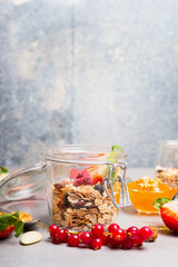 Healthy breakfast with muesli and berries on light rustic kitchen background. Healthy lifestyle and Clean food concept.