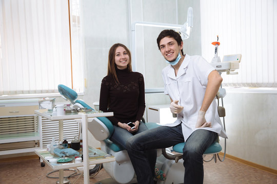 Dentist man with his patient smileing in dental office