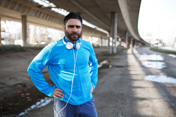 Jogger running on the street under the bridge.