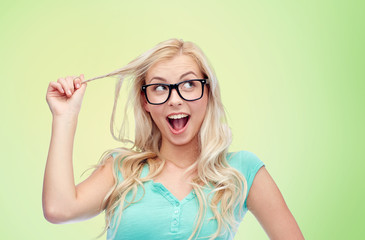 happy young woman or teenage girl in glasses