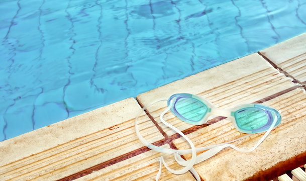 Blue modern Swim goggles on the swimming pool