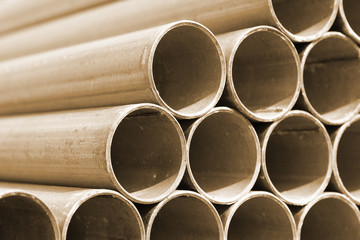 Close - up Stack of construction metal pipes .