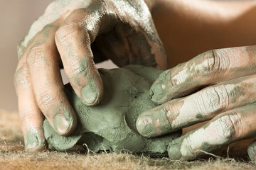 hands working with clay