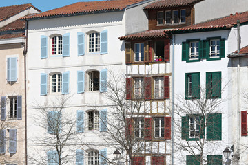 Typical building facade with shutters Basque colors in Bayonne