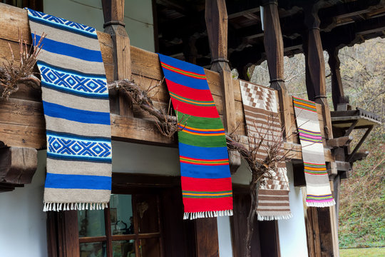 Traditional Bulgarian woven fabrics on the balcony of the wooden house in Etara village, Bulgaria