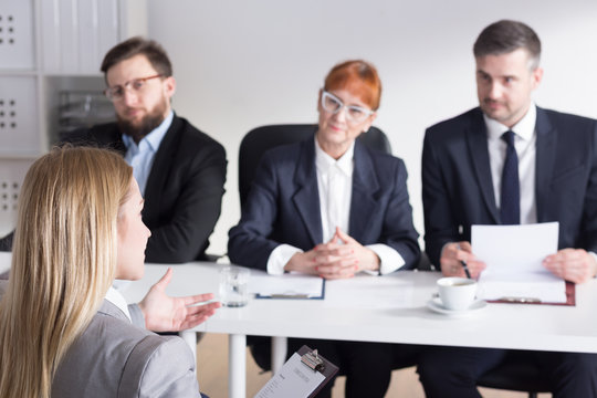 Three businesspeople during job interview with intern