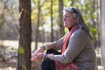 Older Caucasian woman sitting outdoors