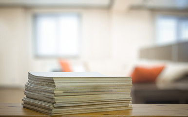 stack of old magazines on wooden table