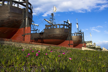 Spanish antique wooden boats exposed on land. The photo is adorn