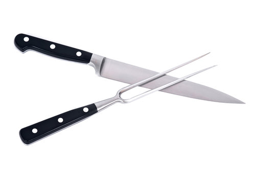 Carving knife and fork separated on white background