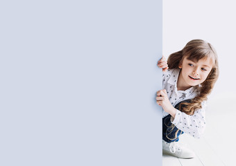 Cute little girl holding sign isolated on neutral background