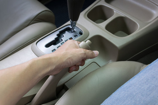 Driver Pulling The Hand Brake In Car