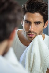 Fototapeta premium Man wiping his face with napkin