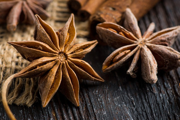Cinnamon and anise on rustic wooden background