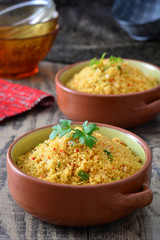 Couscous with vegetables on rustic wood
