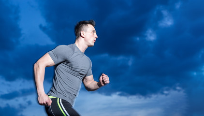 healthy man jogging in the city at early morning in night