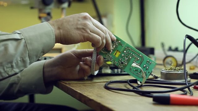 Scientist in laboratory sits in the workplace and parses the device 
