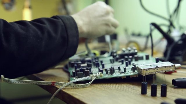 Scientist in laboratory sits in the workplace and parses the device 
