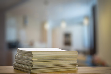 stack of old magazines on wooden table