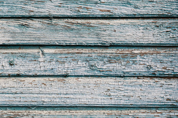 Old blue cracked paint on wooden background