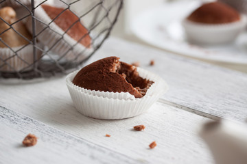 Muffins with spelt flour and cocoa in a wooden box on a table, closeup.