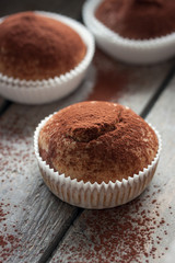 Muffins with spelt flour and cocoa in a wooden box on a table, closeup.