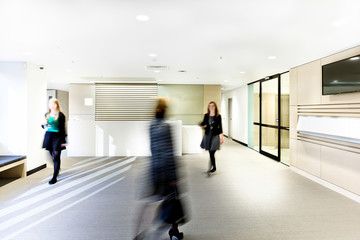 Modern reception room with three women and tv