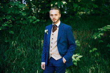 Groom portrait in forest at a wedding day