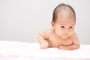 Asian baby lying on stomach