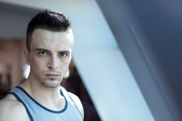 Portait of young fitness model training at home on rooftop