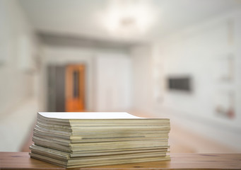 stack of old magazines on wooden table