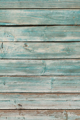 Old blue cracked paint on wooden background