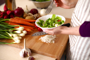 Young Woman Cooking in the kitchen. Healthy Food