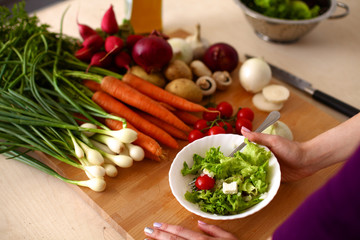 Young Woman Cooking in the kitchen. Healthy Food