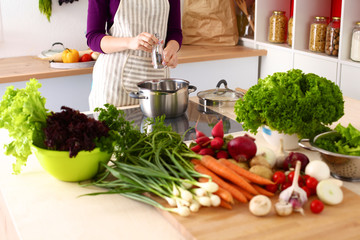 Young Woman Cooking in the kitchen. Healthy Food