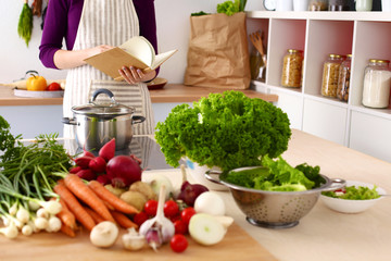 Young Woman Cooking in the kitchen. Healthy Food