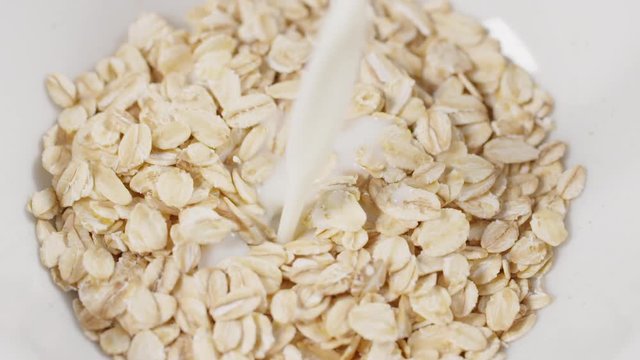 oat flakes pour milk white bowl closeup slow motion footage, prores footage