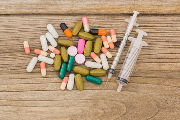 Medical pills of medicine on the wooden floor.