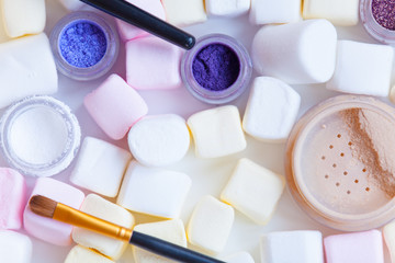 Fototapeta na wymiar marshmallow and cosmetics on the table