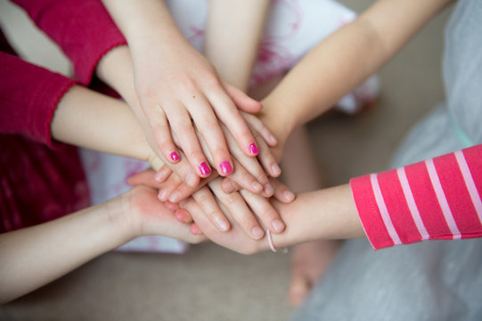 Girls putting hands together, close up