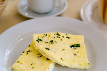 Breakfast with omelet on  table in  cafe