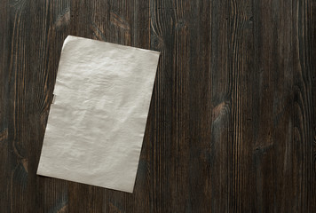 paper on old wooden background