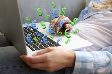 Making money online concept. Woman using laptop with dollar and euro bills coming out, indoors