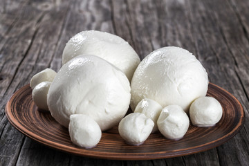 mozzarella balls on a clay dish, close-up
