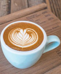 hot latte art on wood plate