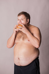 a fat man with a burger in his hand