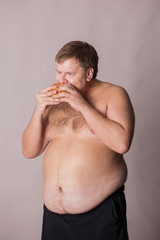 a fat man with a burger in his hand