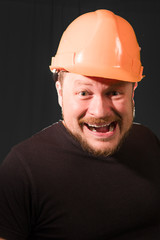 Worker in safety helmet emotional portrait